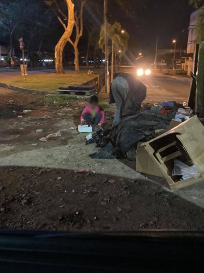 father from kedah rummages through dumpster to find old boxes to sell