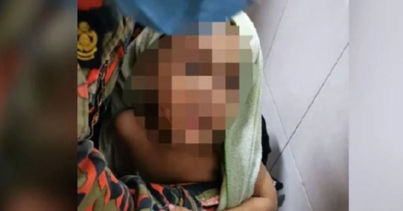 abang bomba resort to cartoons to calm a boy while they free his foot out of drain hole