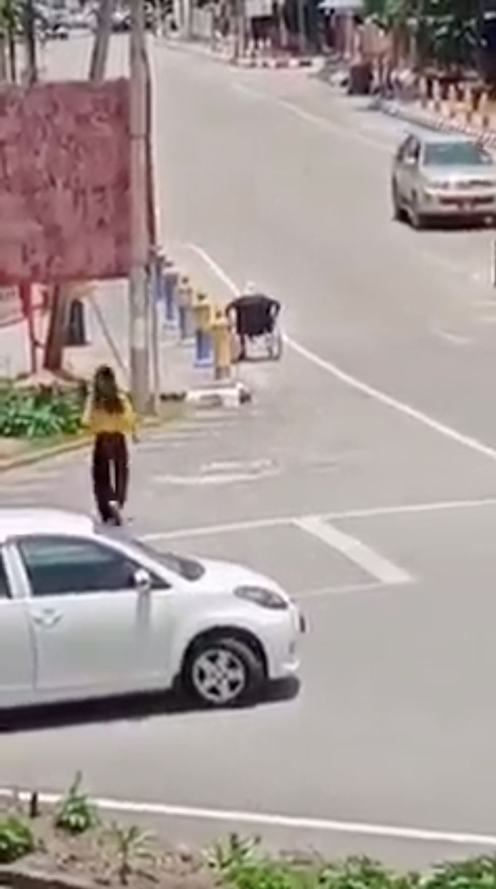 msian woman helps struggling elderly in wheelchair by giving her a ride
