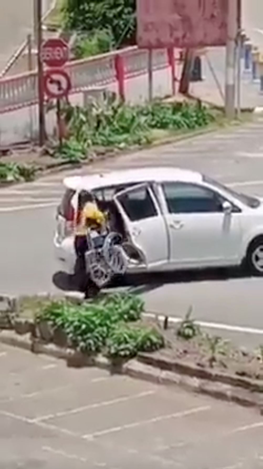 msian woman helps struggling elderly in wheelchair by giving her a ride