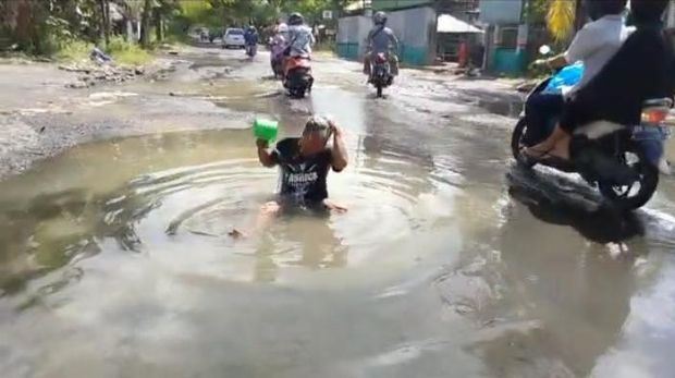 giant pothole where viral man fished and took baths finally gets fixed