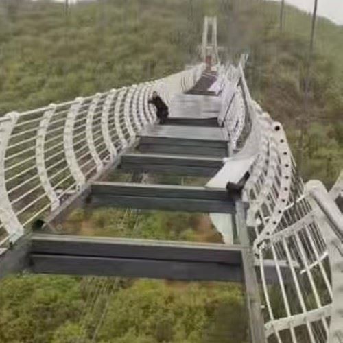 man left dangling from 30-foot glass bridge after glass breaks