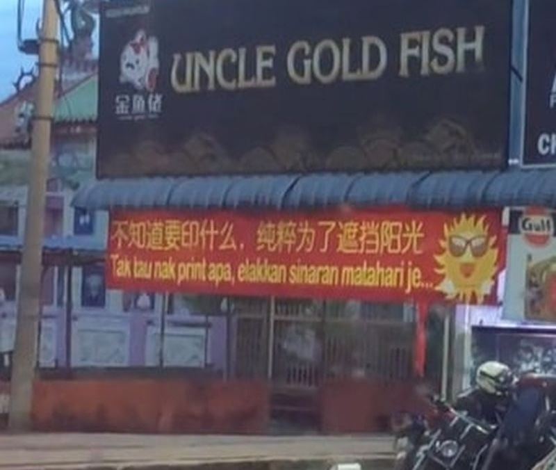 shop in penang puts up banner with “honest message” to block out the sunlight