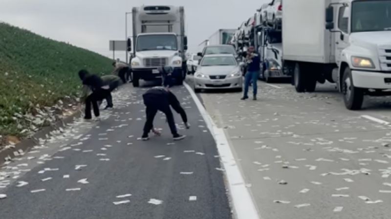 money spills from armoured truck in california causing traffic jam as motorists stop to collect the