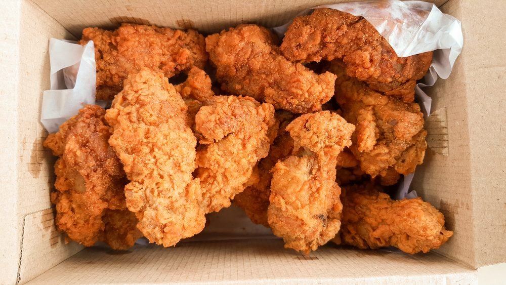 woman finishes kfc fried chicken in front of customs officers after she was stopped from bringing it into singapore from johor