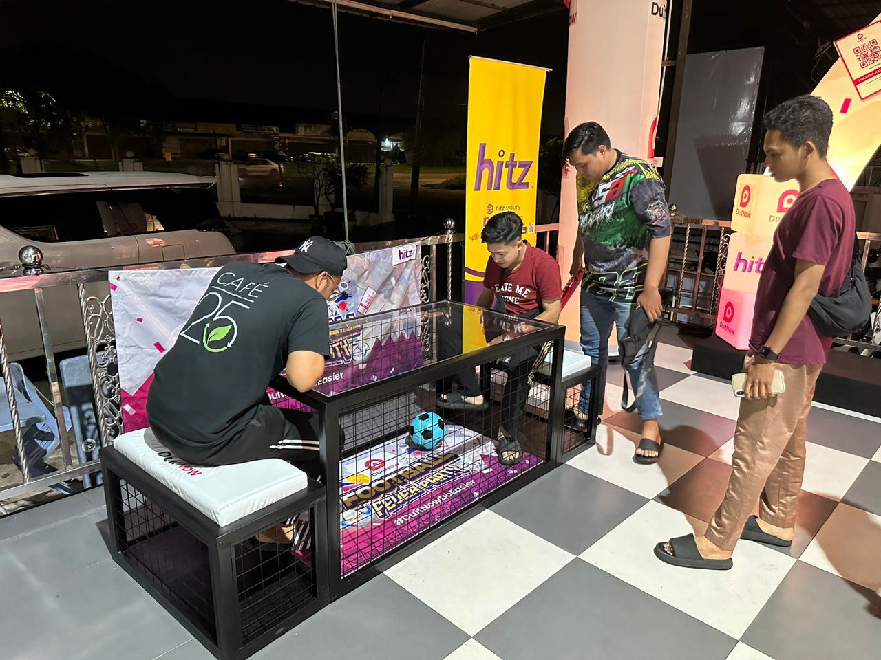 Participants playing a game at DuitNow Football Fever Party