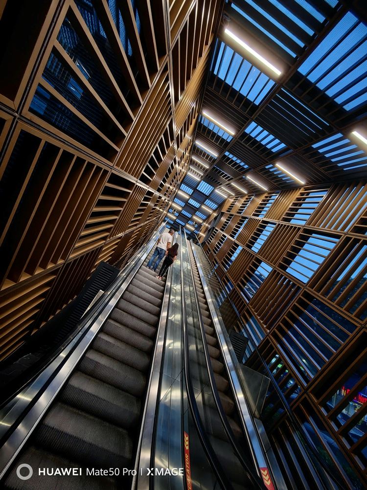 Photo showing escalator and wall design of a building in KL