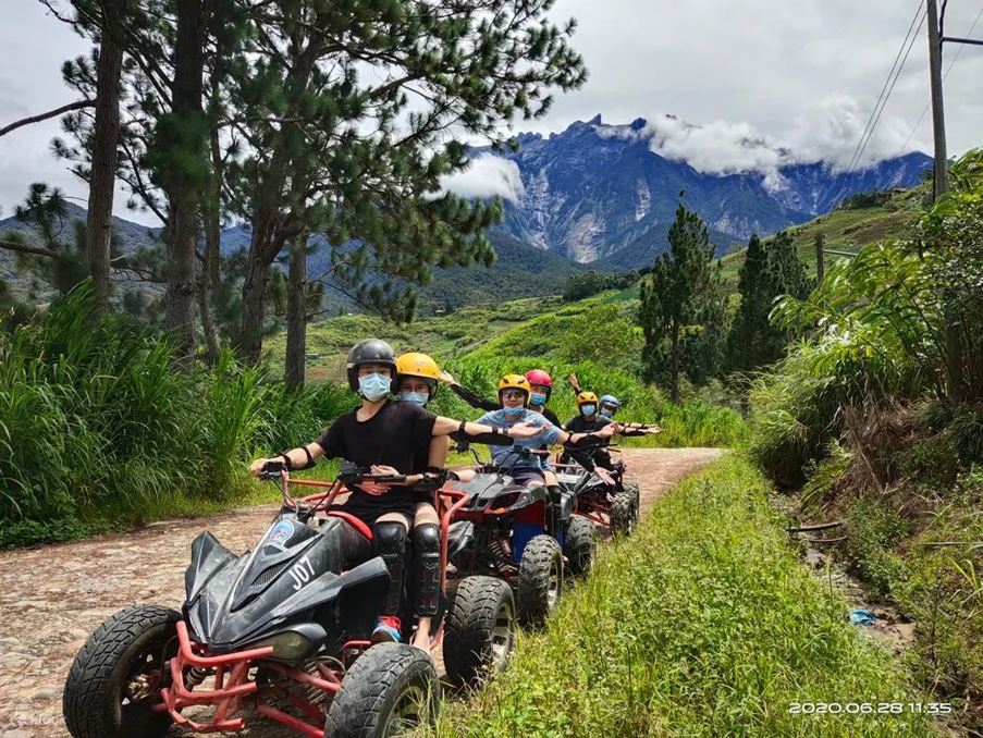 Friends on ATV outdoor ride at Kundasang, Sabah