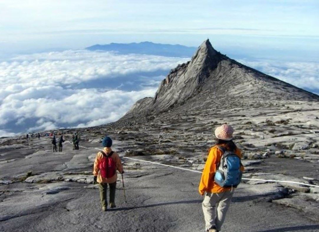 People climbing peak of Mount Kinabalu
