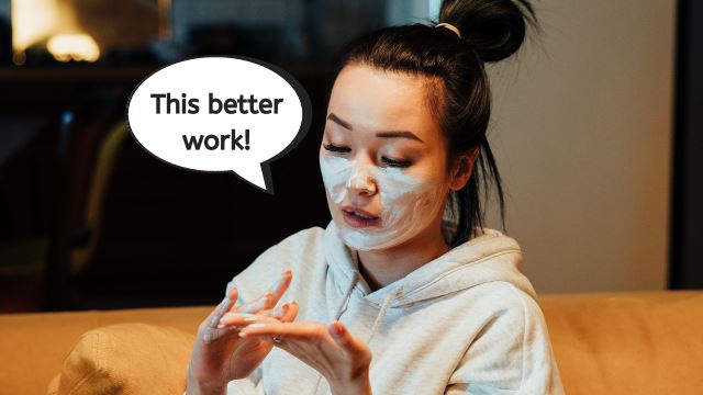 Asian woman applying face mask