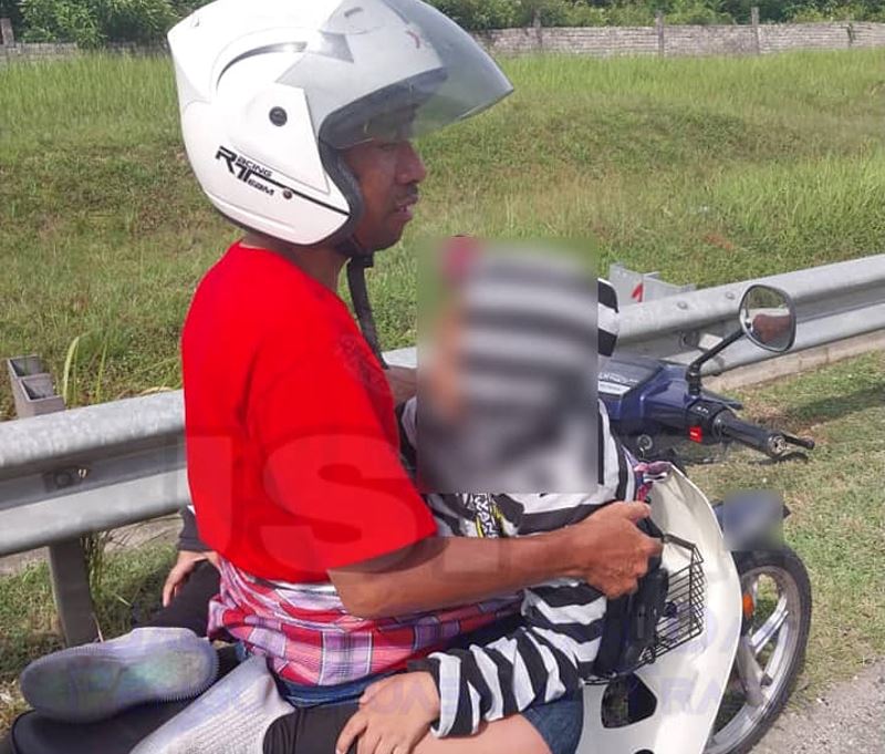 father wraps his son in blanket on motorcycle from perak to kl, pdrm officer sends them home due to safety concerns