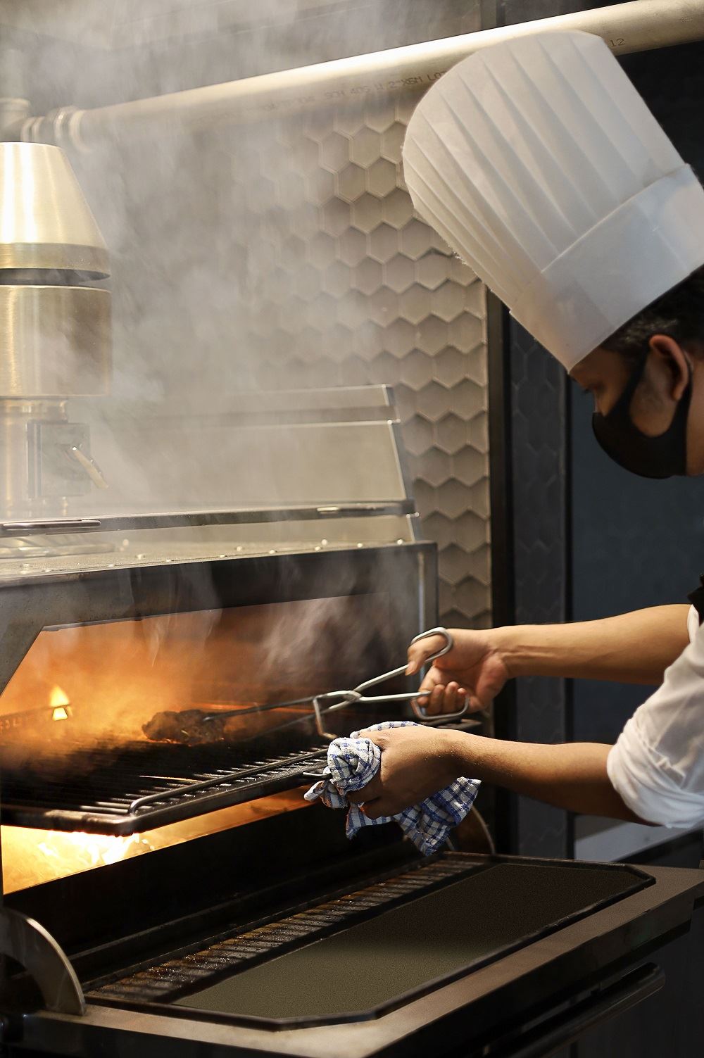 Chef grilling food at Amaya Food Gallery, Amari SPICE Penang