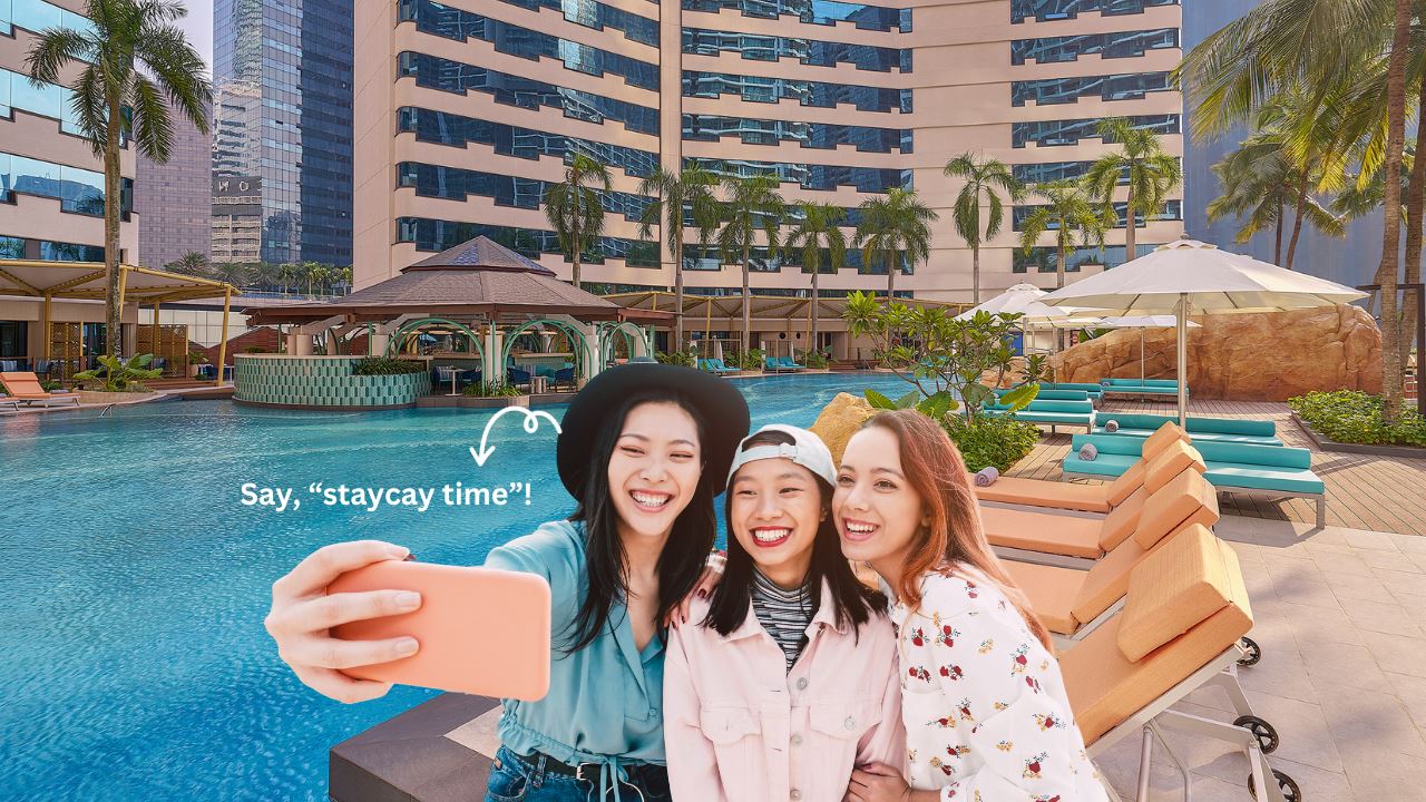 Large swimming pool at Renaissance KL and Asian friends taking selfie