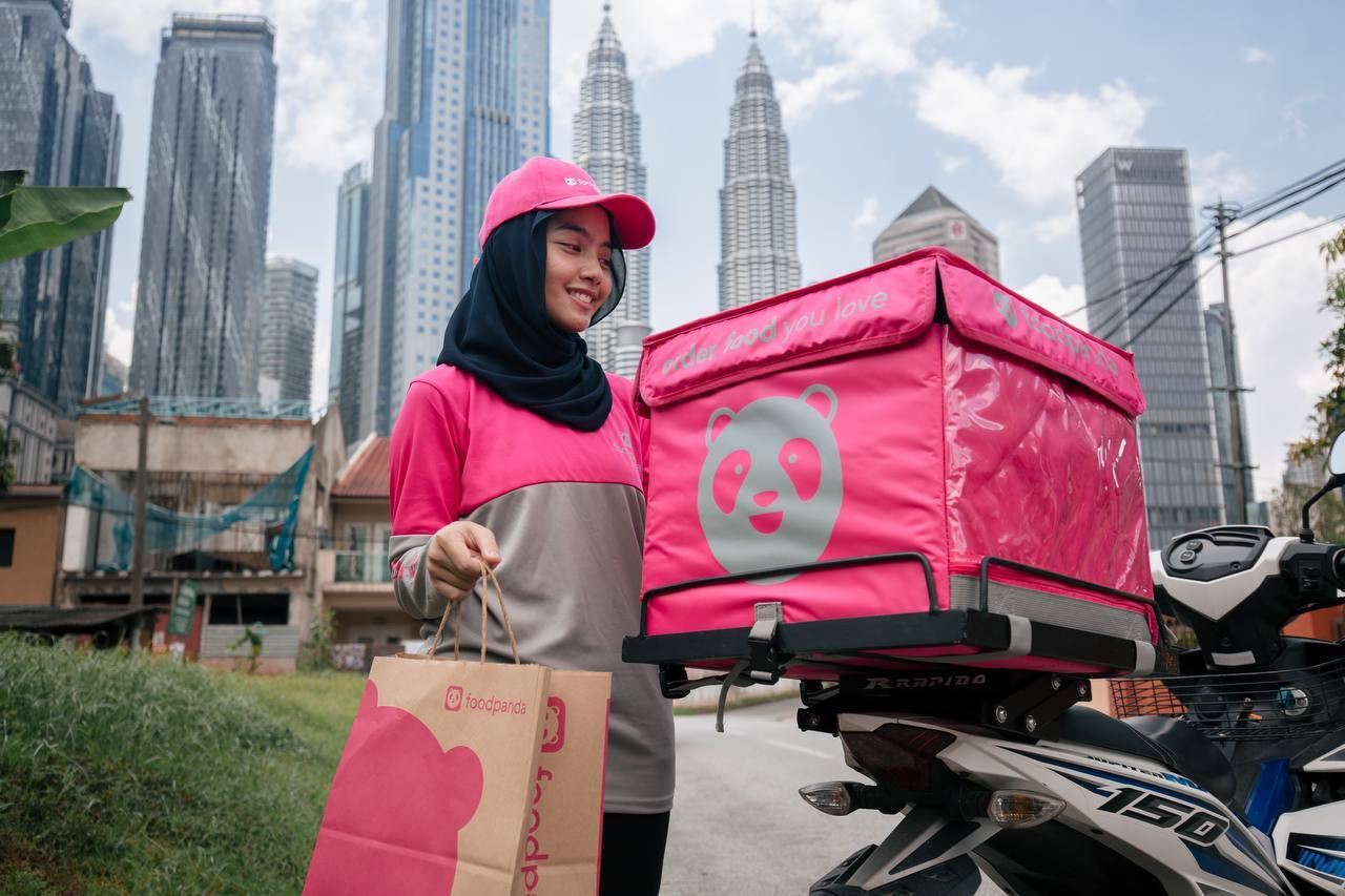 foodpanda rider in uniform holding bag