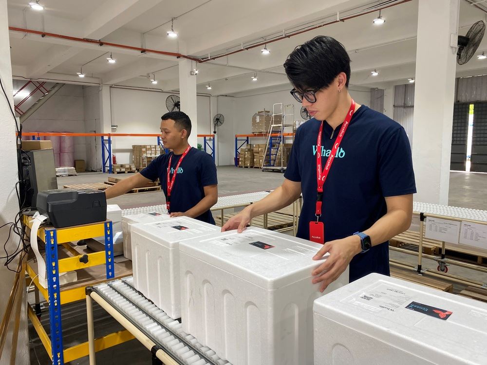 two men holding Styrofoam boxes