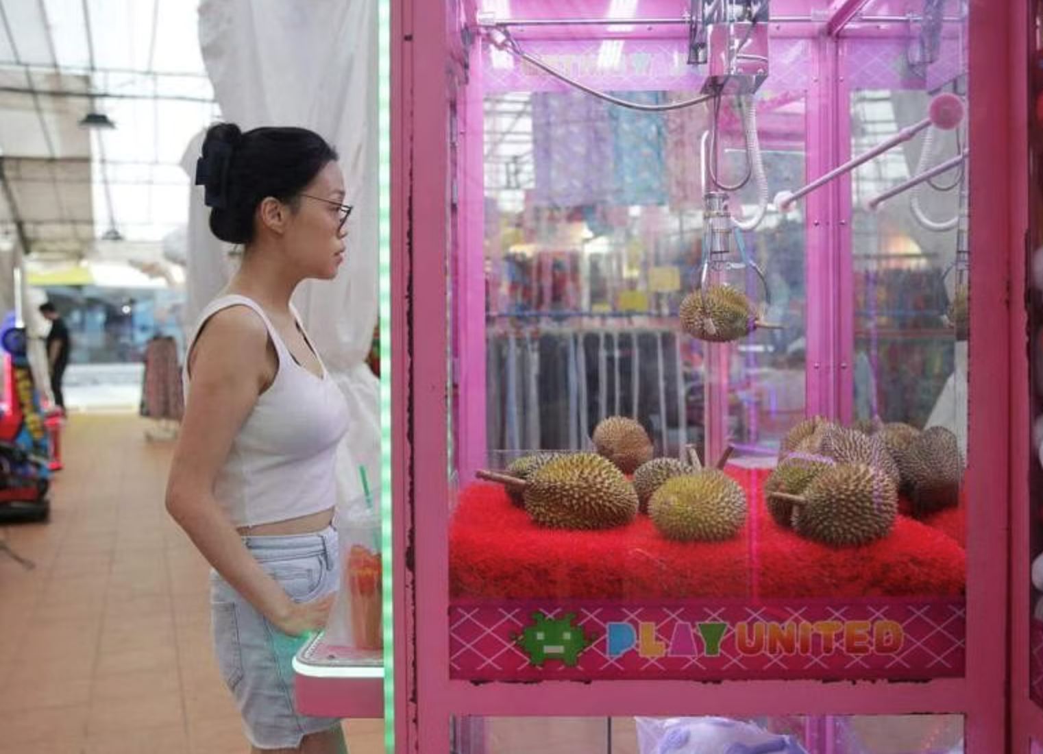 singaporeans flock to durian claw machine: $1 for a taste of the king of fruits