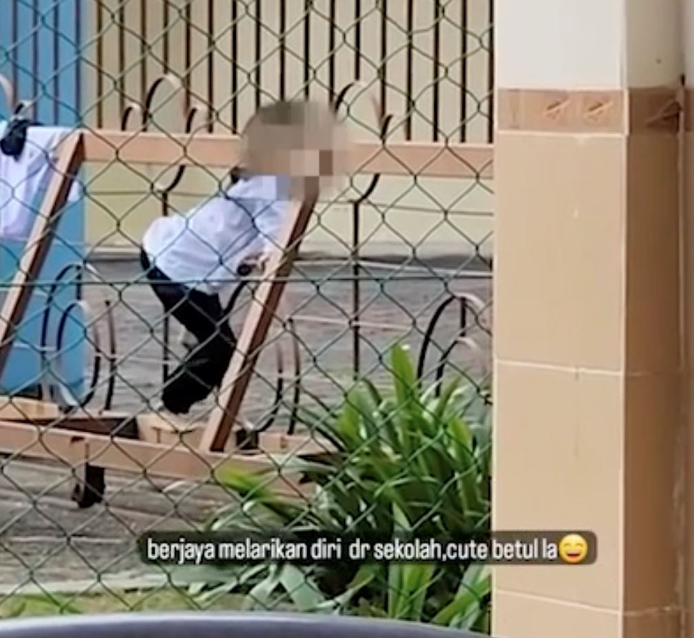primary school student tries to “ponteng” by climbing through gate, caught by guards