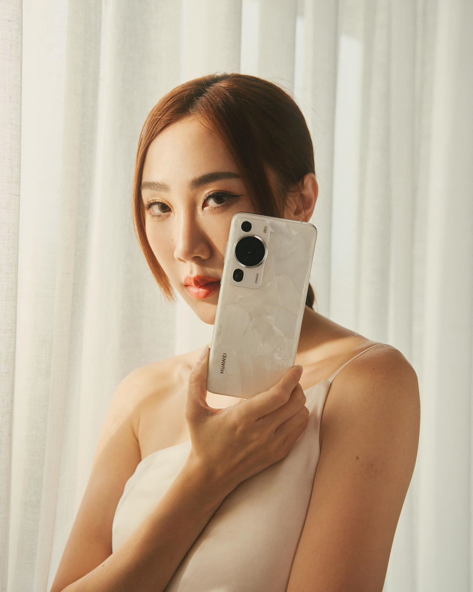 back view of HUAWEI P60 Pro held by Daphne Charice