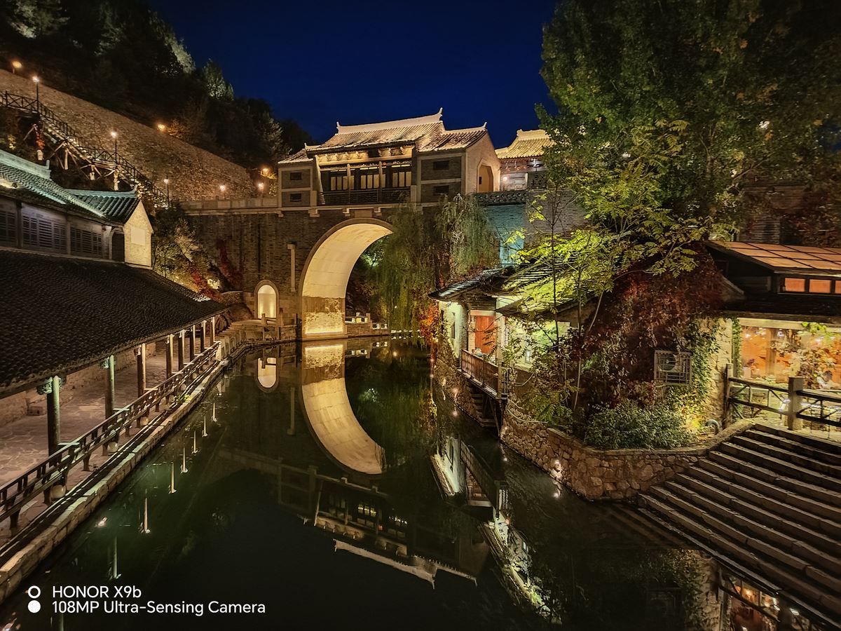 Night view of bridge over a river taken on HONOR X9b