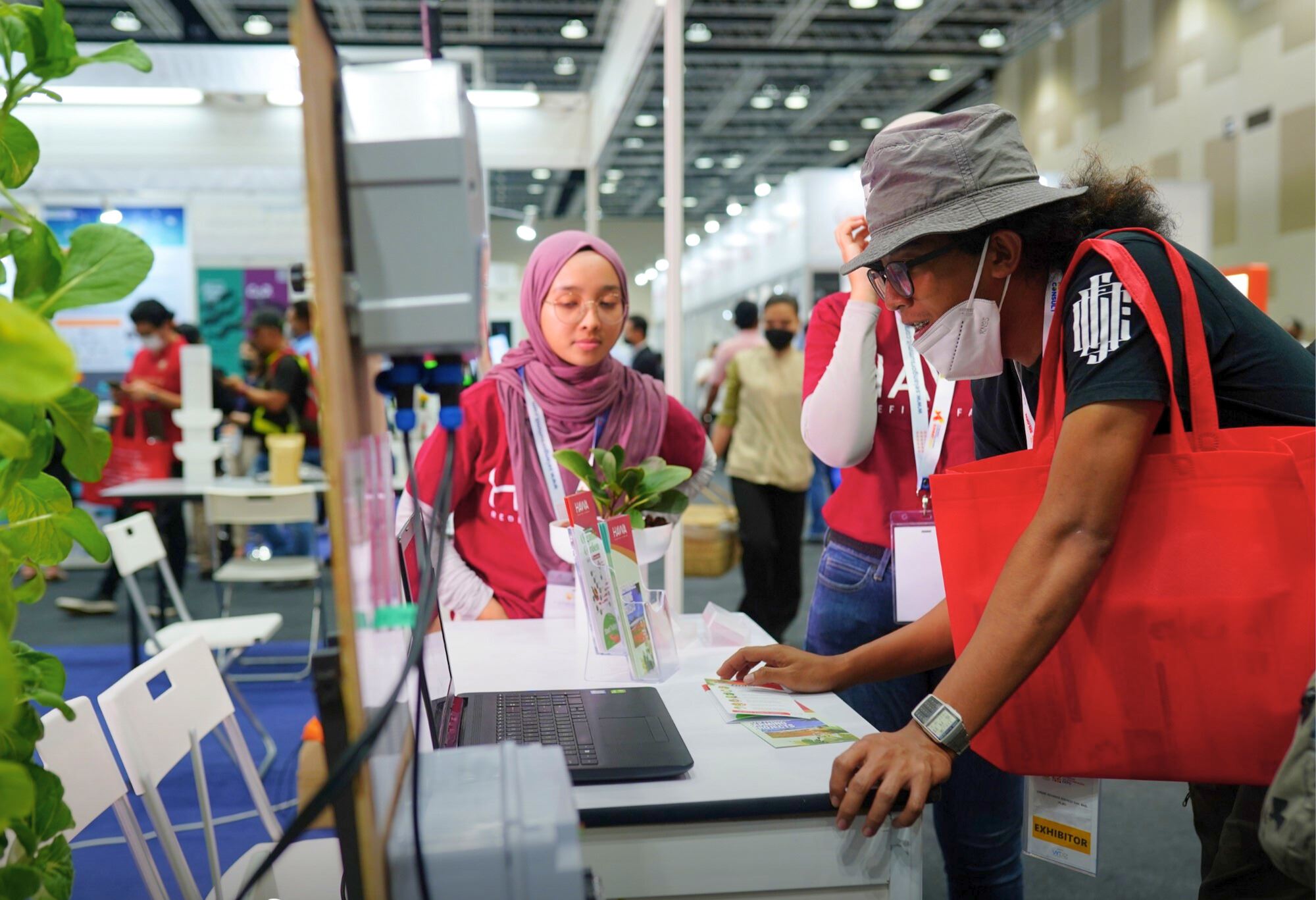 A lady and a man at an exhibition booth