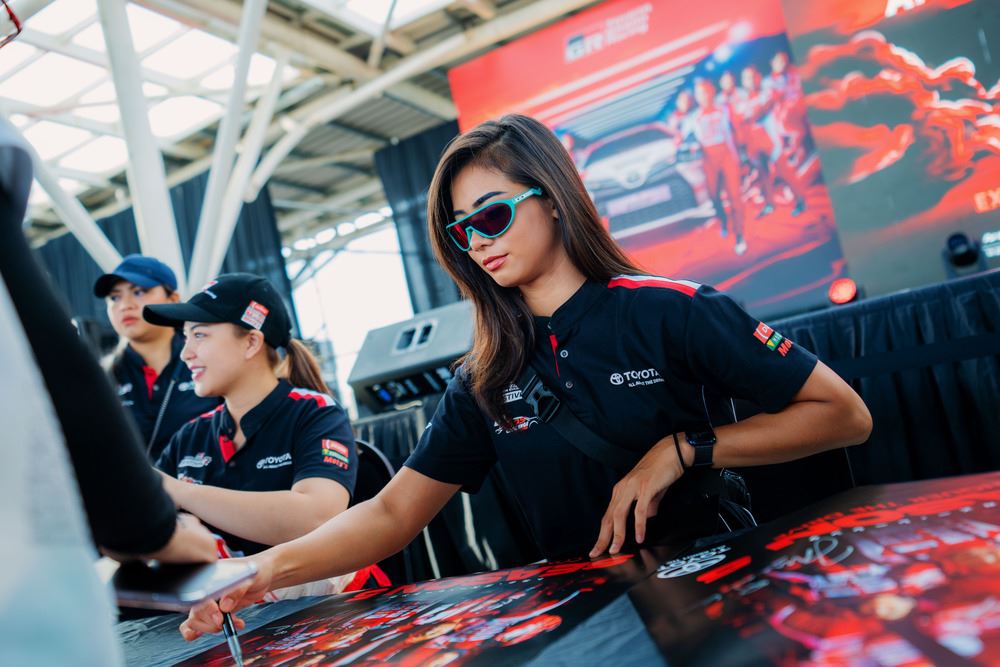 race car driver holding pen