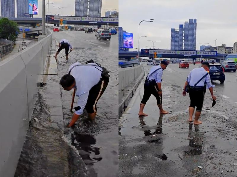 malaysian traffic officers tackle flooding by unclogging drains on major kl road