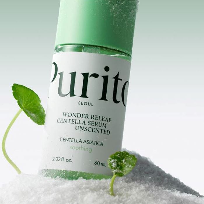 A bottle of serum with leaves at the sides