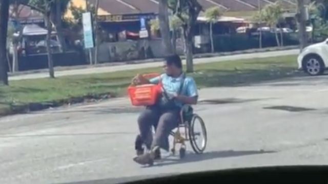 determined malaysian pushes wheelchair backwards to sell cakes despite disabilities