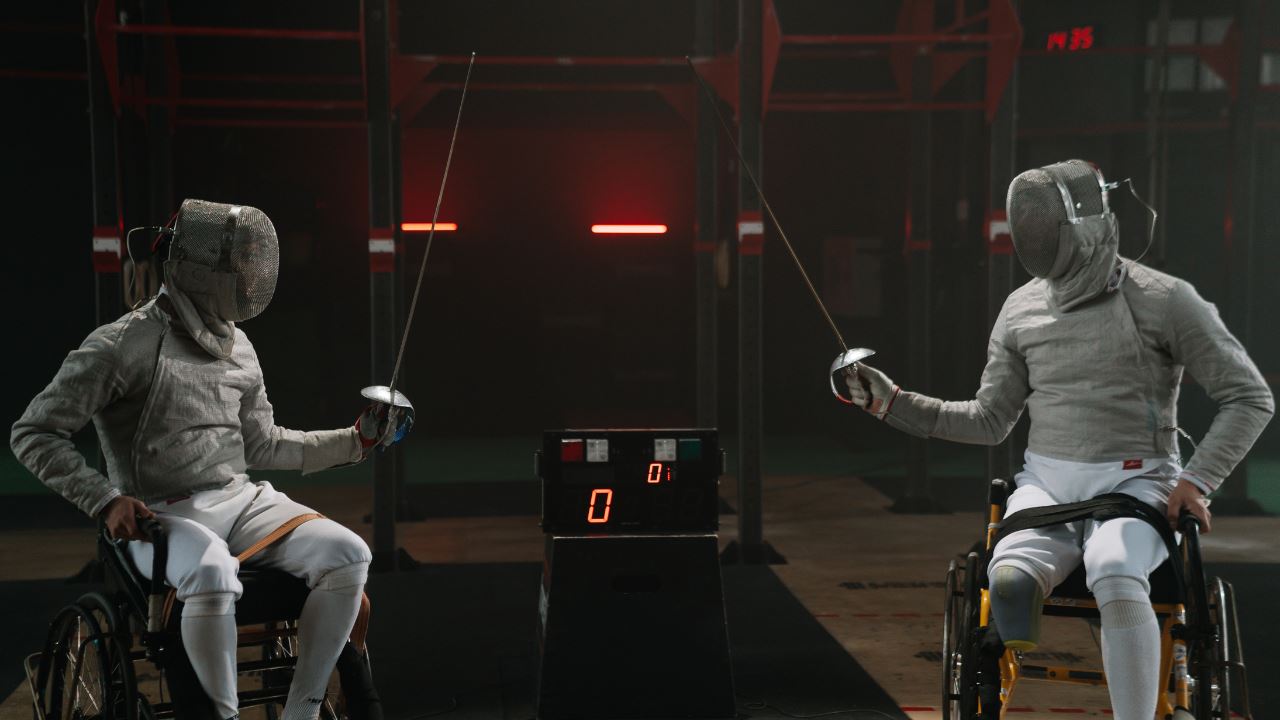 Two paralympics para-athletes fencing