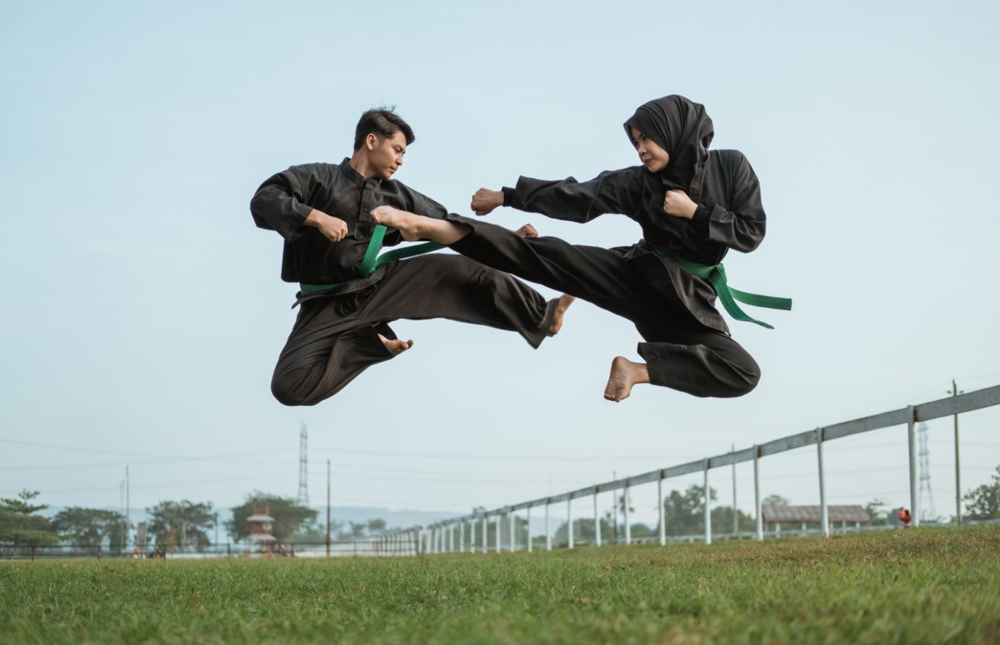 man and woman in silat fight