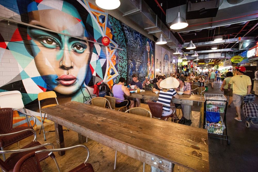 A group of people sitting and eating at a market