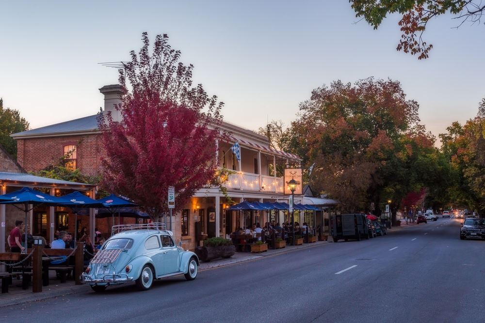 A building, a car, trees and a road