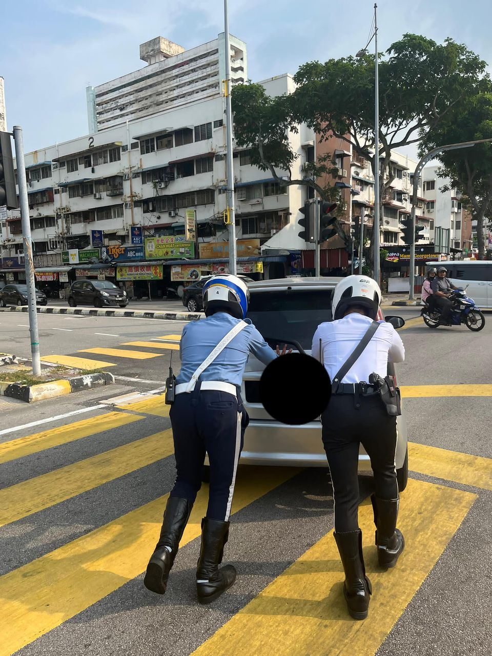 malaysian netizens praise penang officers pushing stranded car to the roadside!