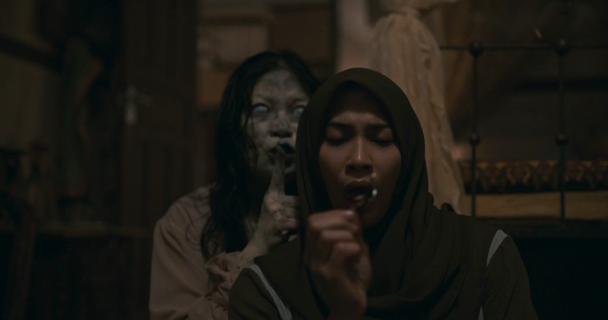 A ghost standing behind a woman