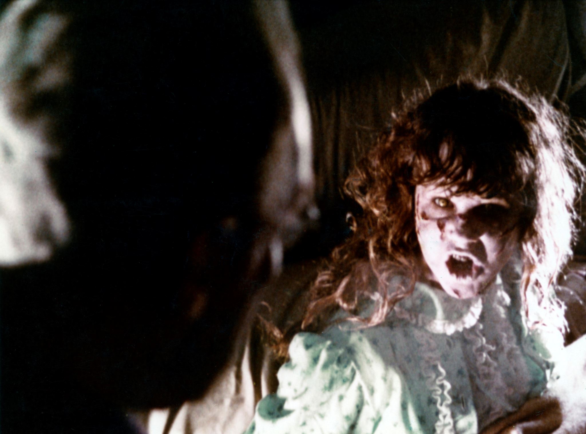 A possessed child talking to a priest