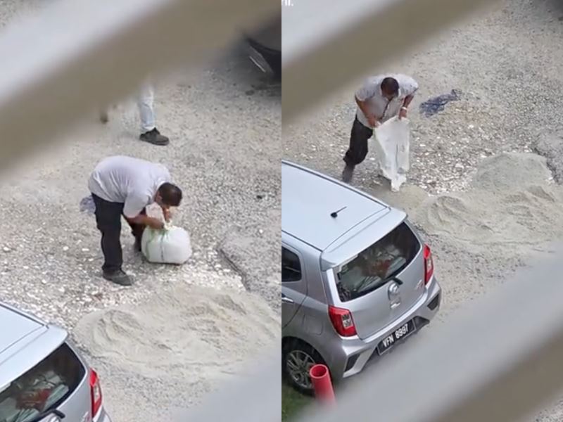 malaysians praise kind uncle for covering pothole in the rain to help drivers
