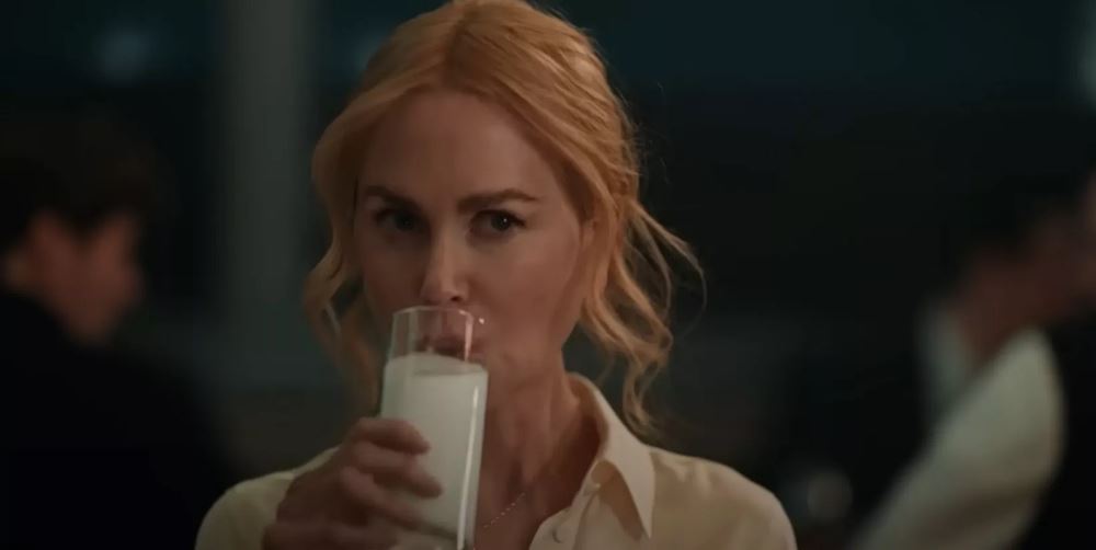 nicole kidman raises a glass of milk while accepting award