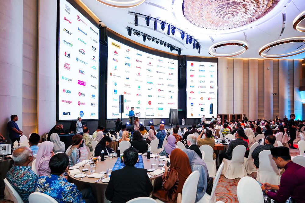 A group of people looking at large screens