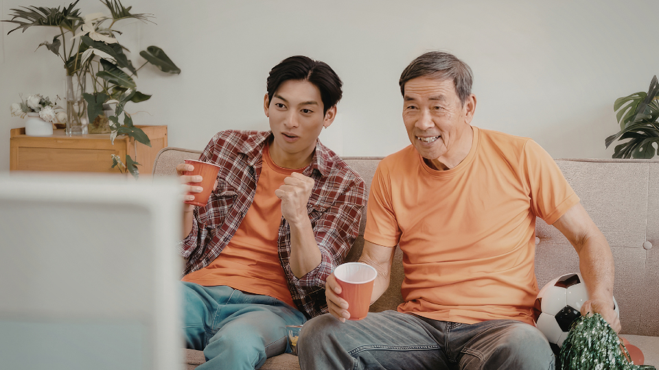 A father and son watching a game together