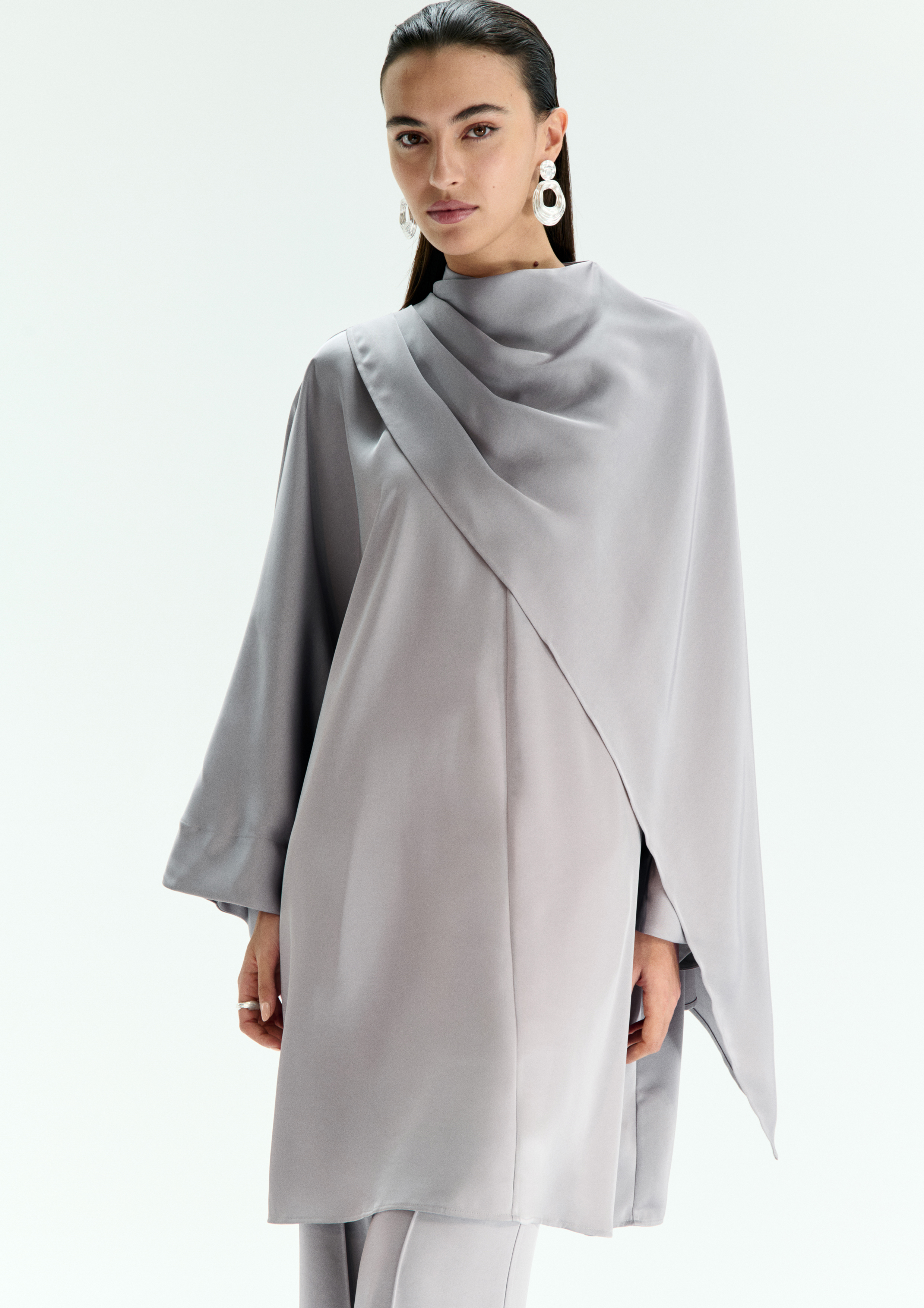 A model posing in a grey top