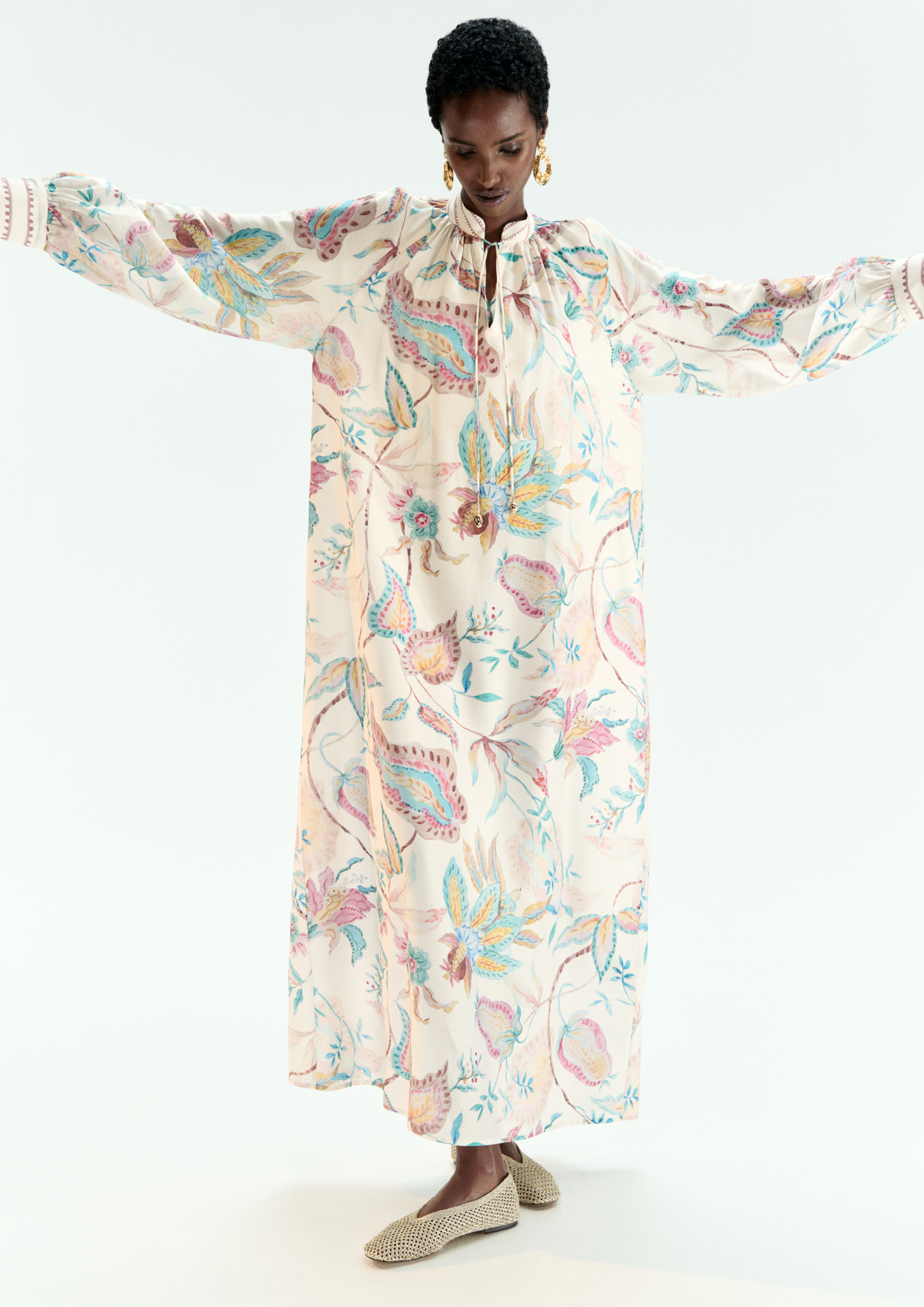 A model posing in a printed kaftan