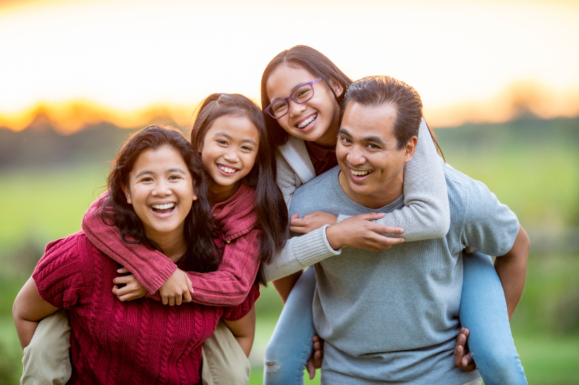 A shot of a family smiling at the camera