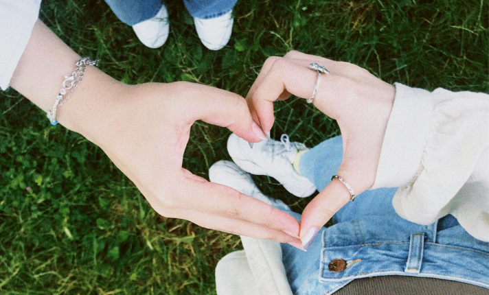 Two hands making a heart shape with their fingers