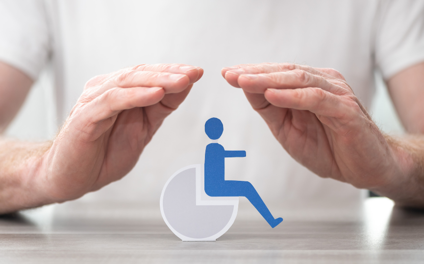 A symbolic image of hands shielding a disabled person