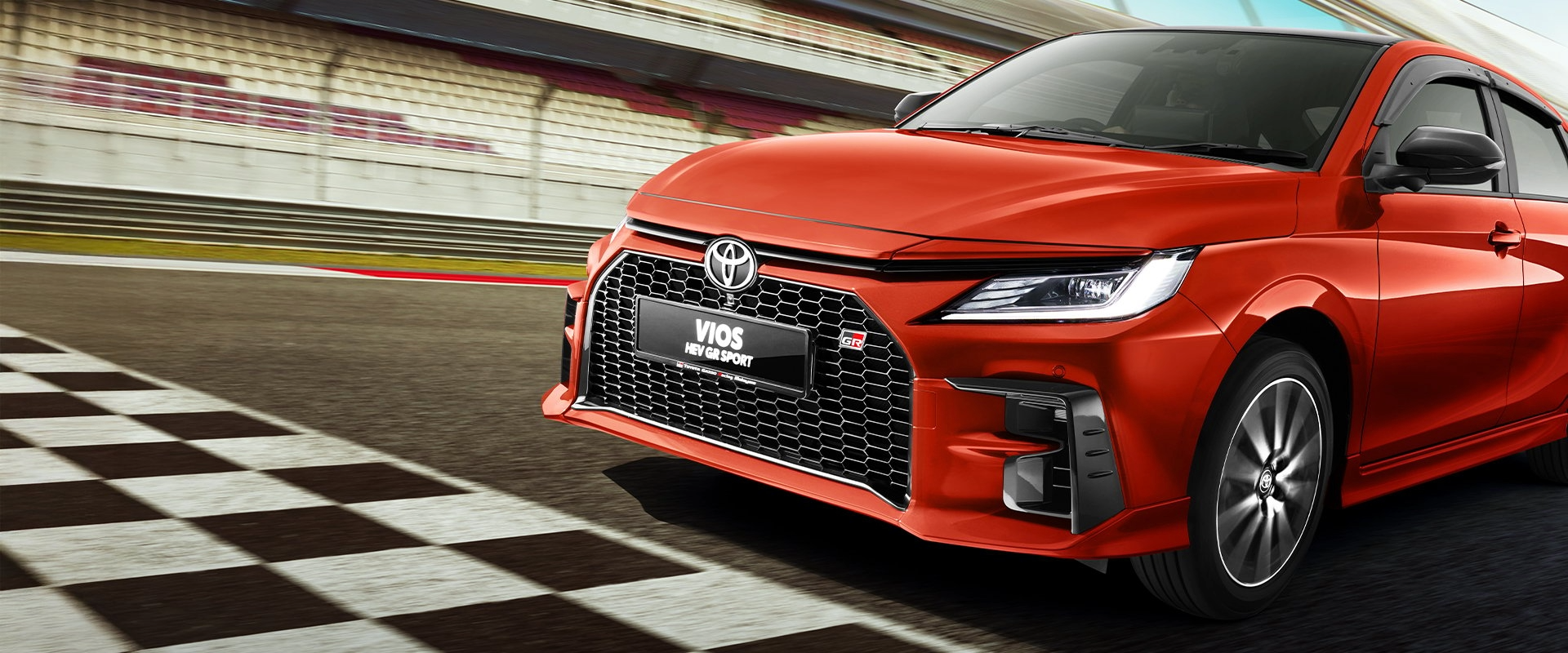 A red Toyota Vios HEV GR Sport on the race track